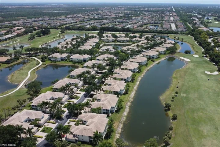 Birds eye view of property with a water view