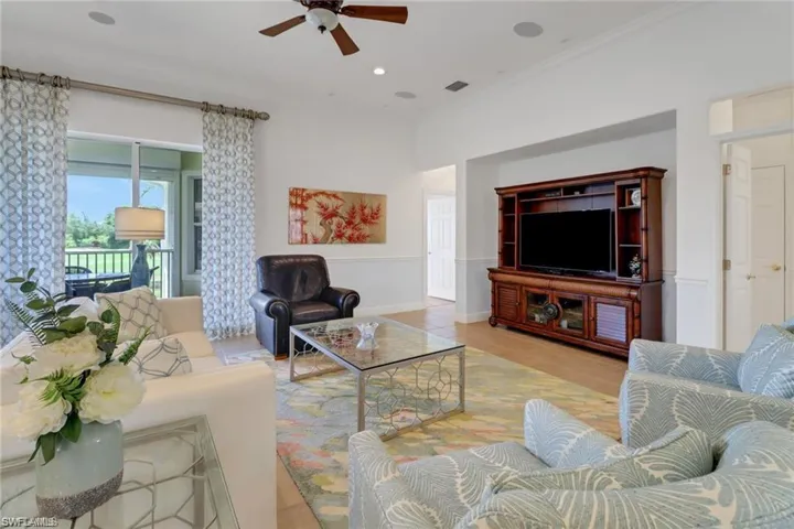Living room with light wood-type flooring and ceiling fan