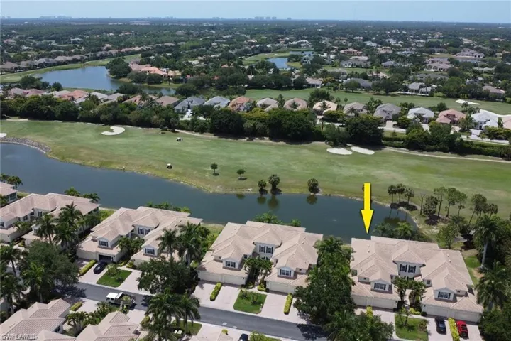 Birds eye view of property with a water view