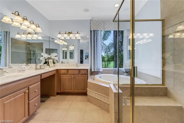 Bathroom featuring tile patterned flooring, independent shower and bath, and vanity