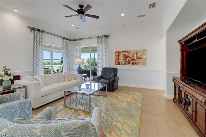 Living room featuring ceiling fan and light tile patterned flooring
