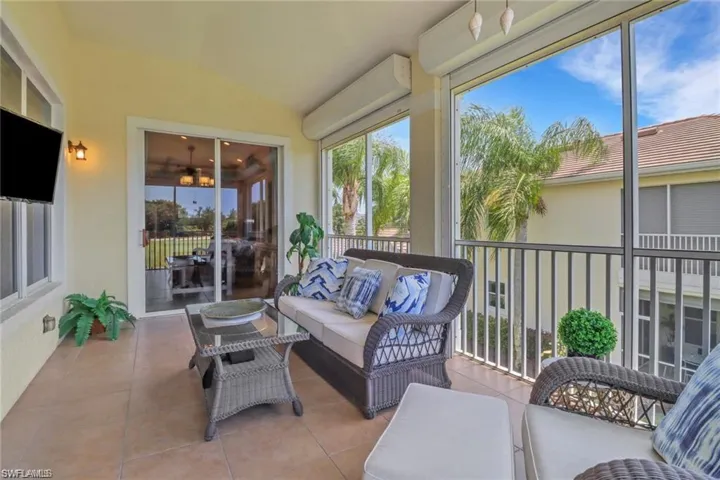 Sunroom with vaulted ceiling and an inviting chandelier