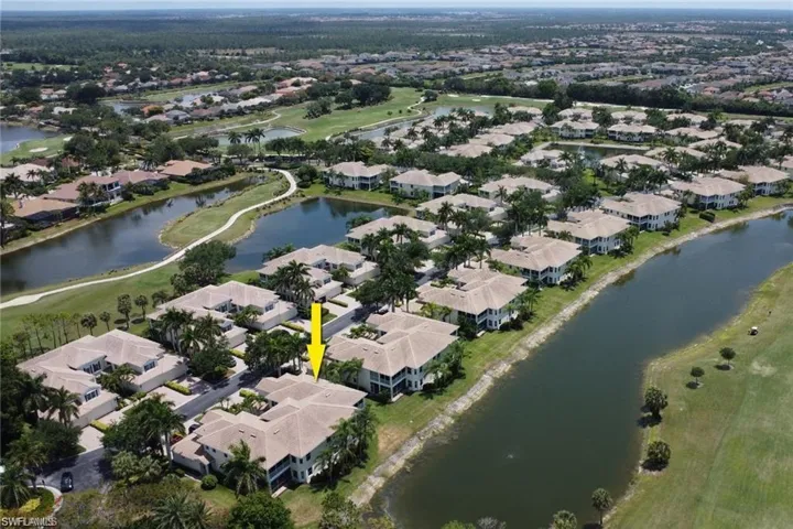 Birds eye view of property with a water view