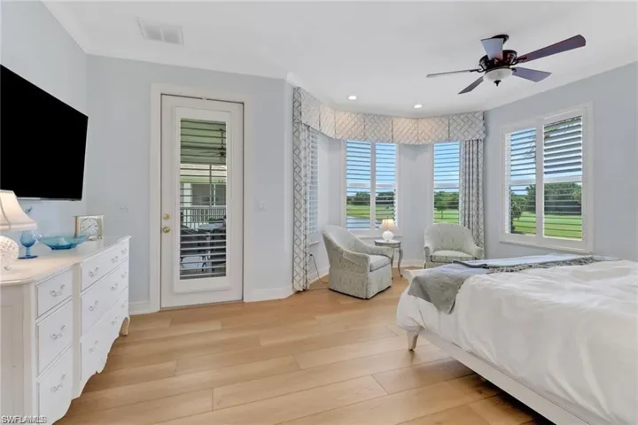 Bedroom with ceiling fan, light hardwood / wood-style floors, and access to exterior