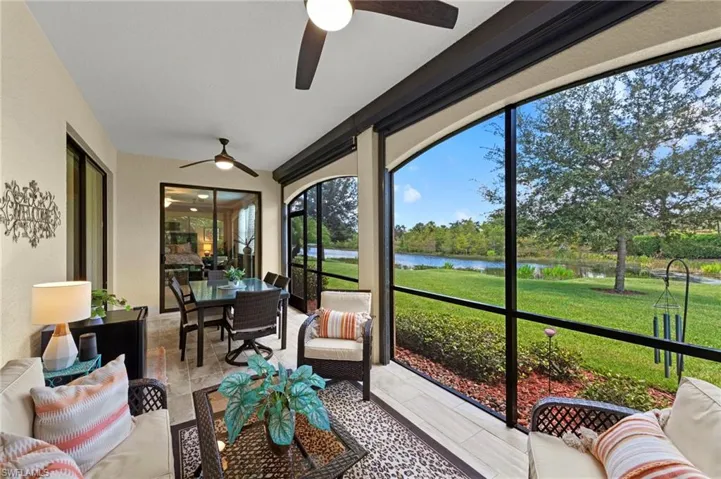 Tiled lanai featuring a water view new modern ceiling fans, electronic remote and storm protection screens