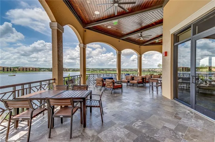 Outdoor dining area of clubhouse overlooking lake