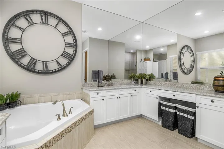 Bathroom with independent shower and bath, vanity, and tile patterned floors