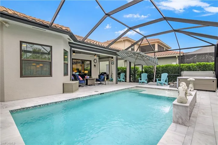 View of pool featuring a patio area, a lanai, ceiling fan, and pool water feature