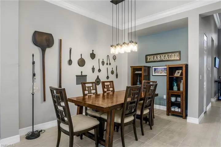 Tiled dining area with crown molding