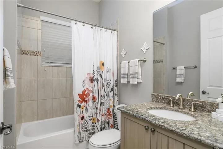 Full bathroom featuring vanity, toilet, and shower / tub combo