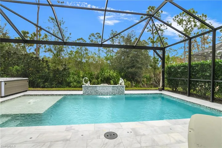 View of swimming pool featuring a lanai, a patio, and pool water feature
