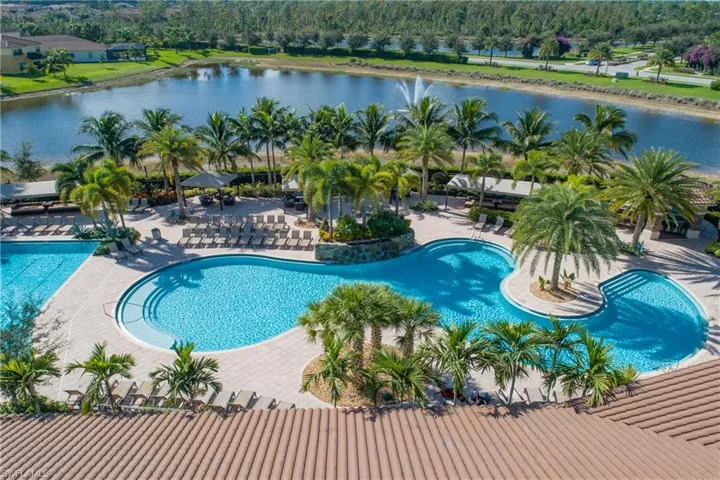 View of swimming pool with a water view and a patio