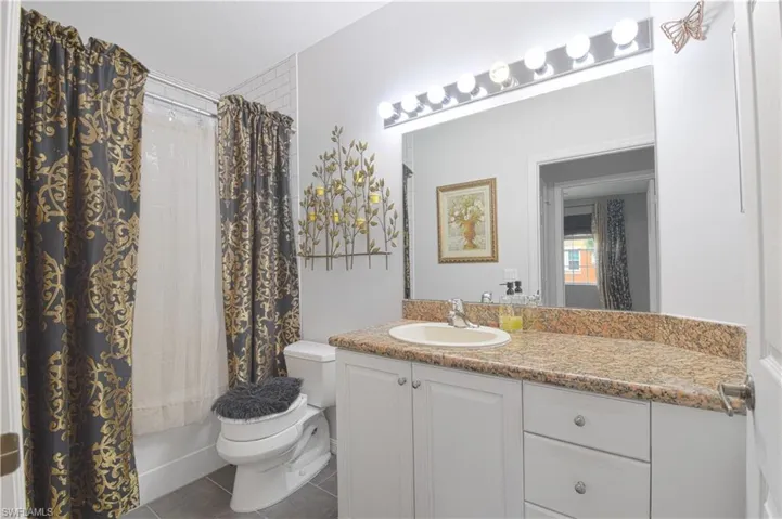 vanity, and shower / tub combo