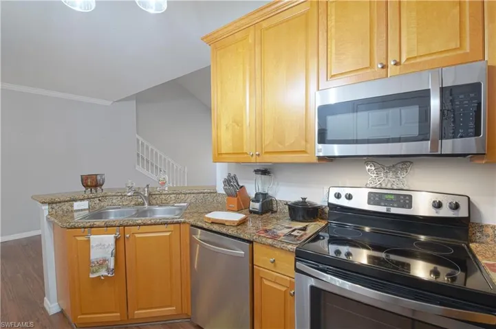 stainless steel finishes, dark wood-style floors