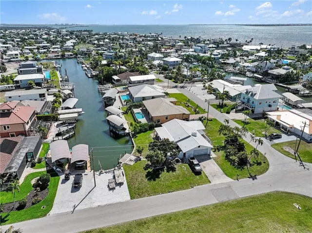 Aerial view of residential area with a nearby access to the gulf and surrounding barrier islands.