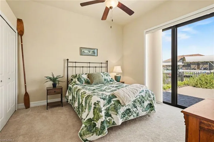 The pool side bedroom featuring access to outside via sliders had a large closet, and ceiling fan to keep your guest cool when they stay.