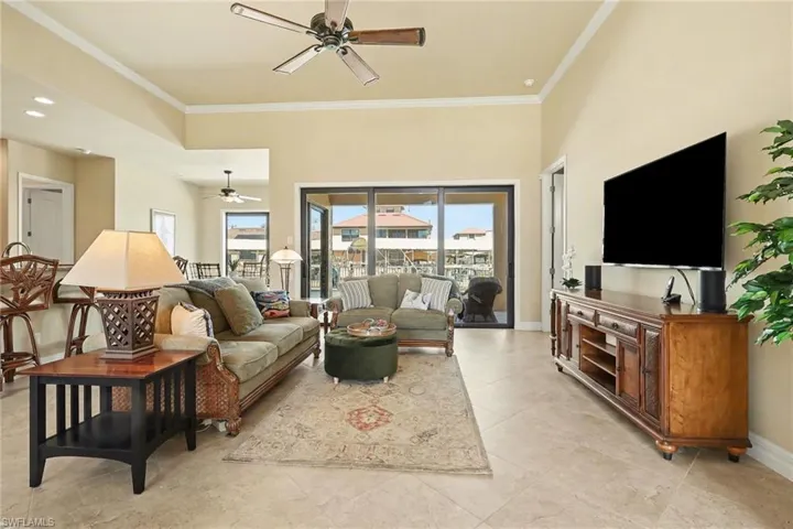 Living area featuring crown molding, highlighting the natural light in the home, ample living space.