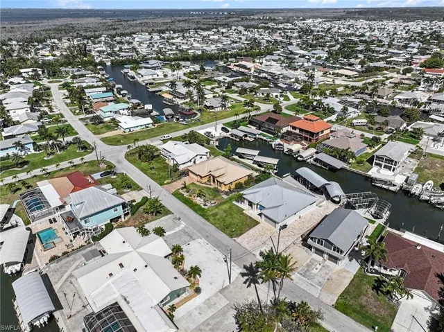 Aerial view of property and surrounding area with nearby suburban area and a nearby canal systems.
