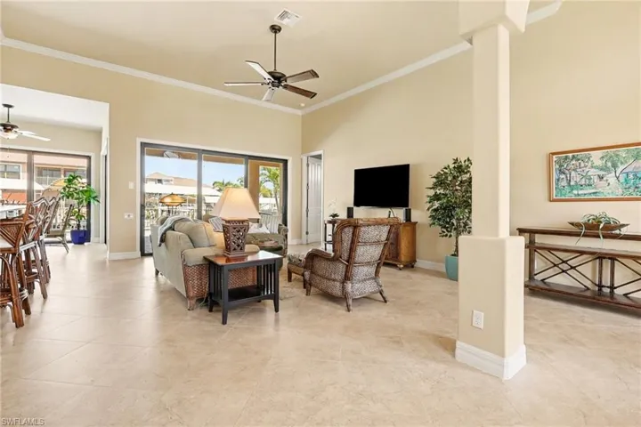 Living room looking out to the pool area showing large living area and beautiful decor.