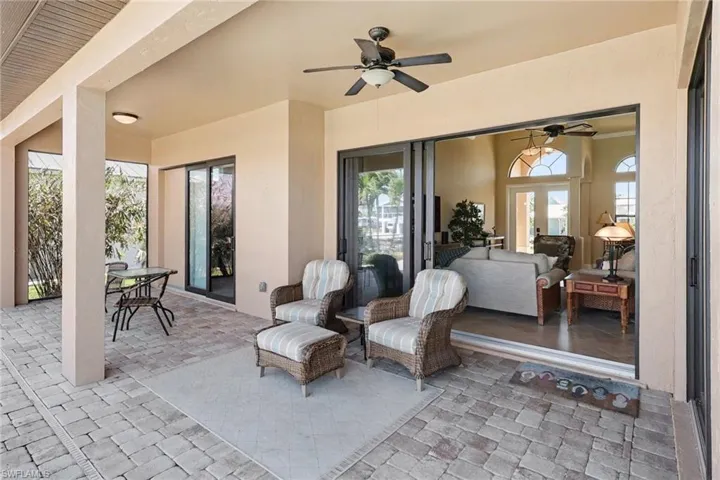 View of patio with a ceiling fan and outdoor dining space