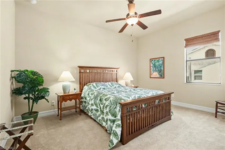 Bedroom with light colored carpet and ceiling fan