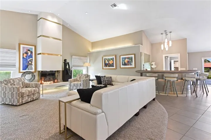 Living room featuring light tile floors and high vaulted ceiling