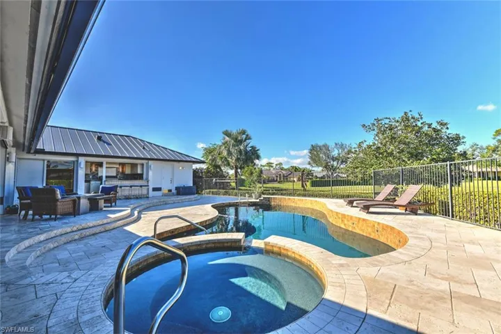 View of swimming pool featuring an in ground hot tub, a patio, and an outdoor living space