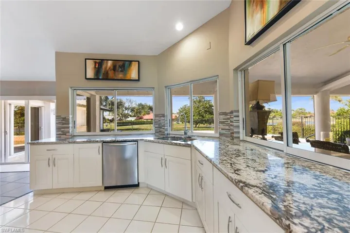 Kitchen featuring lots of counter space, backsplash, white cabinetry, and Bosche dishwasher