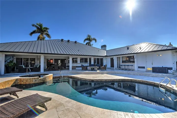 View of pool featuring an in ground hot tub, an outdoor bar, and a patio area