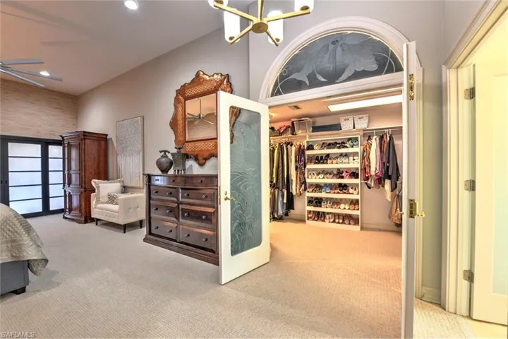 French doors lead to a spacious master walk-in closet with built-ins.