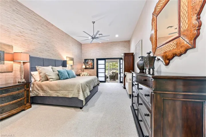 Large owner's suite with ceiling fan and light carpet