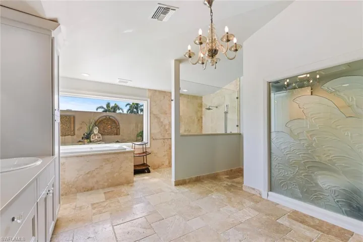 Bathroom with plus walk in shower and custom etched glass.