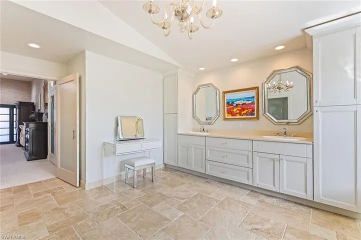 Master bath with dual vanities and dual linen closets.