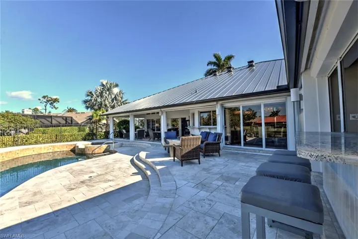 View of patio / terrace with outdoor lounge area and a swimming pool with hot tub