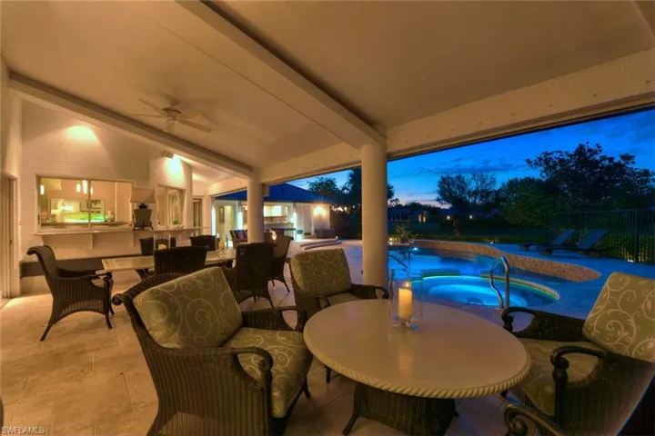 Enjoy entertaining guests on the patio terrace at dusk overlooking the pool & hot tub