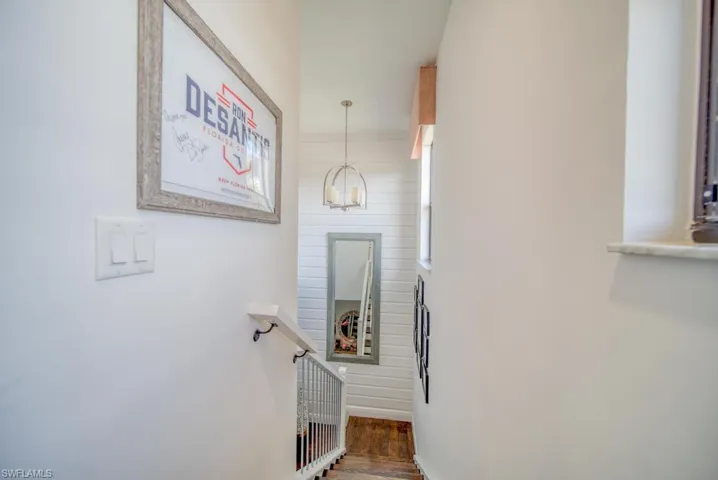 Stairway featuring wood-type flooring