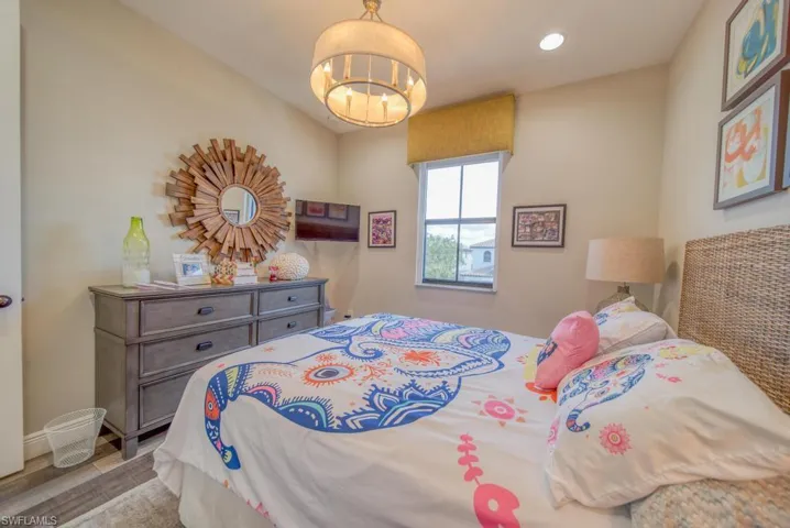 Bedroom featuring a notable chandelier