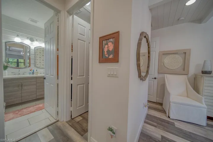 Hallway featuring sink and light hardwood / wood-style flooring