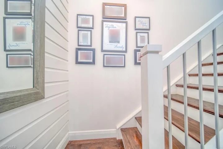 Staircase featuring baseboards and wood finished floors