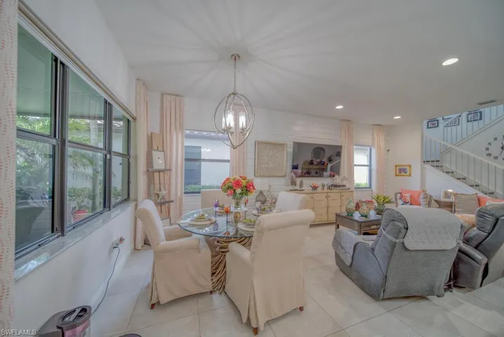 Dining area featuring light tile patterned flooring and an inviting chandelier