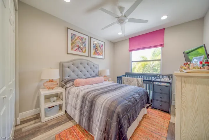 Bedroom with hardwood / wood-style floors and ceiling fan