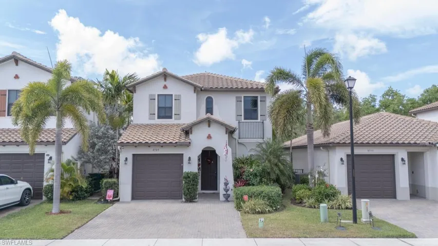 Mediterranean / spanish house with a garage and a front yard