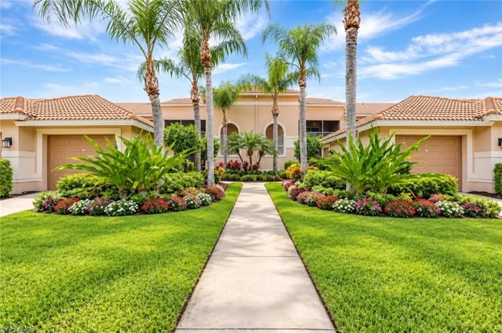 Mediterranean-style architecture with a tile roof, stucco exterior, and attached garage