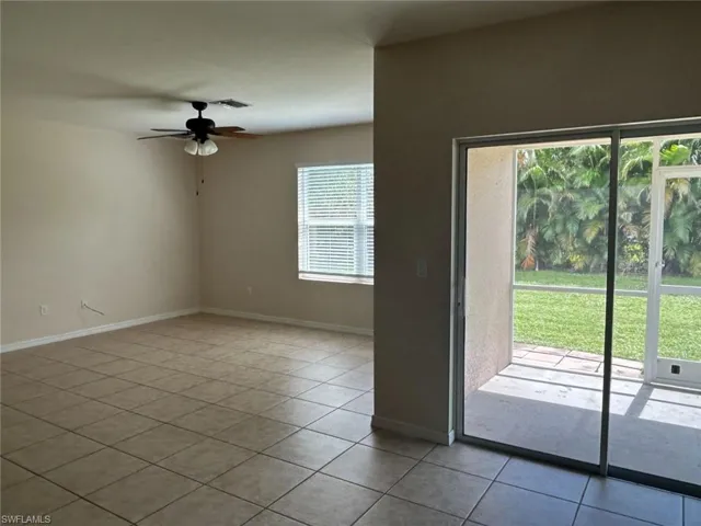 Spare room featuring light tile patterned floors and ceiling fan