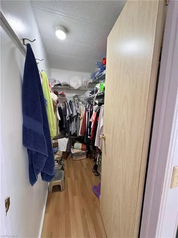 Walk in closet featuring light wood-style floors