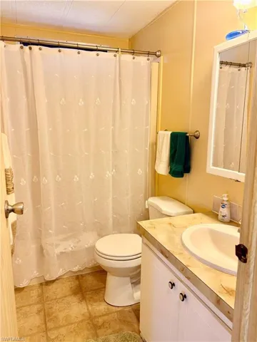 Bathroom featuring vanity and curtained shower