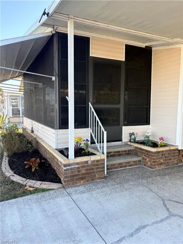 Property entrance featuring a sunroom