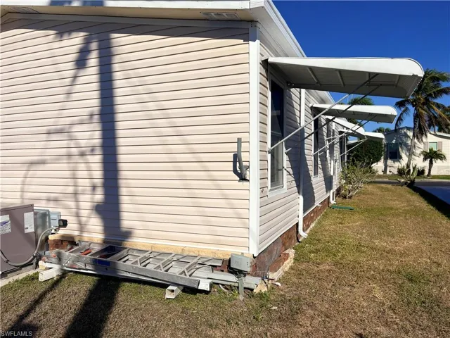 View of side of property with a lawn