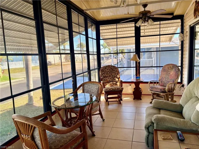 Sunroom with tile patterned floors and wood ceiling