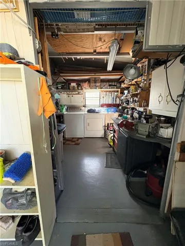 Basement with washing machine and dryer and a workshop area